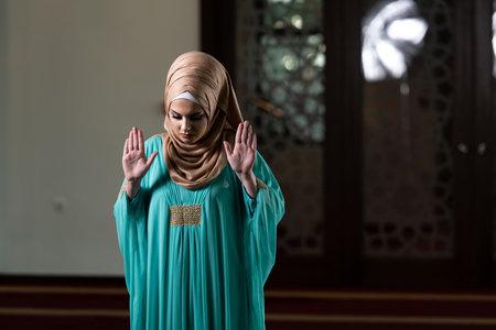 Young Muslim Woman Is Praying in the Mosque