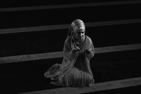 Humble Muslim Woman Is Praying in the Mosqueの写真素材