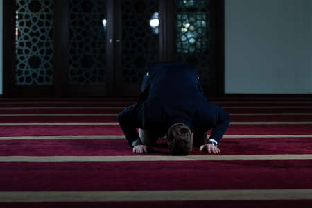 Attractive Man Making Traditional Prayer to God Allah in the Mosqueの写真素材