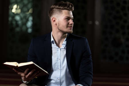 Attractive Man Making Traditional Prayer to God Allah in the Mosqueの写真素材