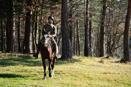 Young Man Rider With Her Horse Enjoying Good Mood in Evening Sunset Lightの写真素材