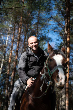 Portrait of Confident Male With Horse Standing on Fieldの写真素材