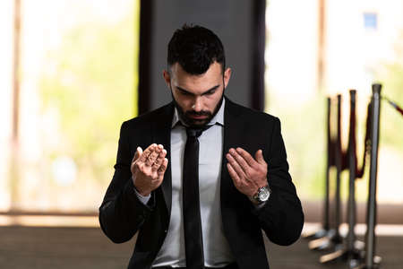 Attractive Man Making Traditional Prayer to God Allah in the Mosqueの写真素材