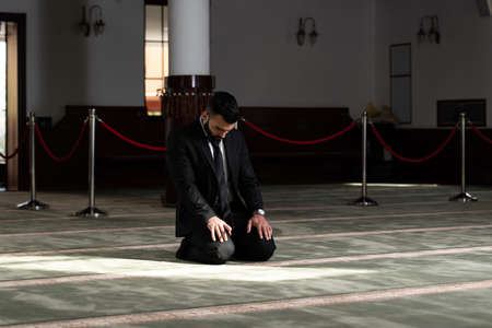 Portrait of a Young Adult Muslim Man is Praying in the Mosqueの写真素材