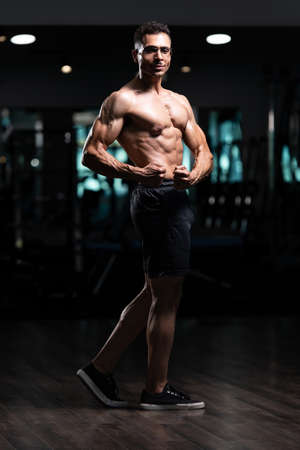 Portrait Of A Young Physically Fit Man With Gynecomastia Breasts Problem Showing His Well Trained Bodyの写真素材