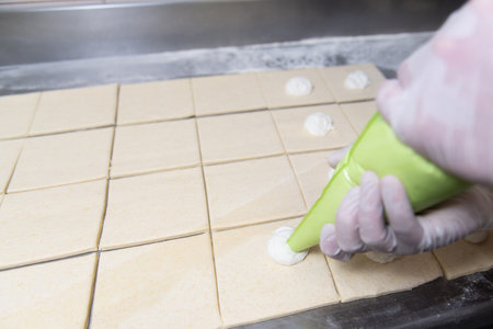 Young Pastry Chef Making Some Cheese Croissant in the Bakery Cooking Process Before Going to the...