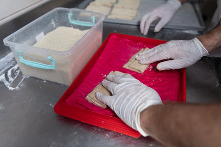 Young Pastry Chef Making Some Sweet Snack in the Bakery Cooking Process Before Going to the Ovenの写真素材