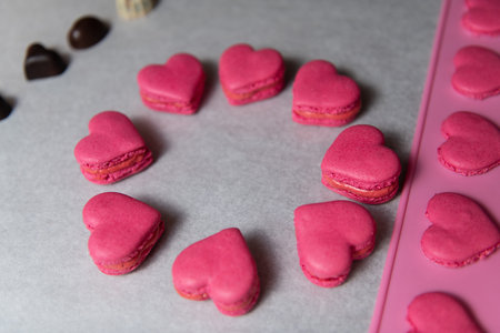 Close Up Red Heart Macarons Dessert on Baking Parchment Paper
