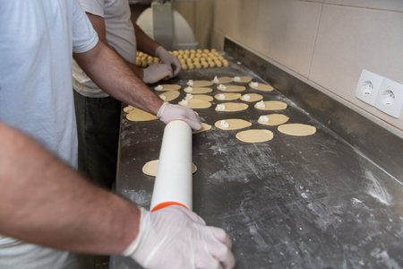 Young Pastry Chef Making Some Dessert with Cheese in the Bakery Cooking Process Before Going to the Ovenの写真素材