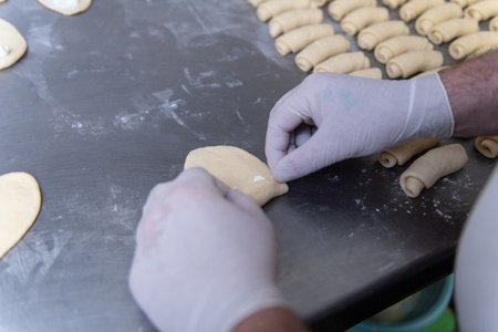Young Pastry Chef Making Some Dessert with Cheese in the Bakery Cooking Process Before Going to the Ovenの写真素材