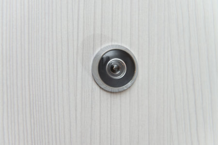 Door Lens Peephole On White Door Background - Copy Spaceの写真素材