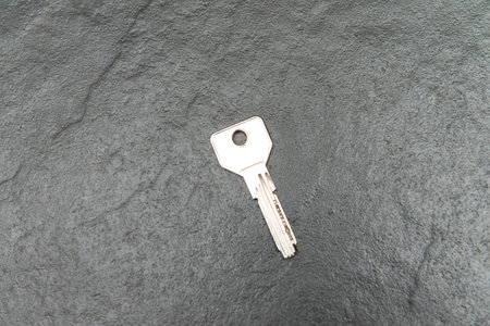 Metal Key on Grey Background Copy Space Close Upの写真素材