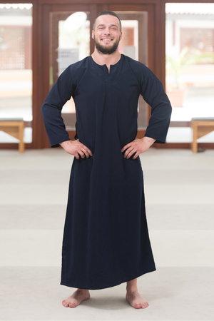Portrait of a Young Muslim Man Making Traditional Prayer To God Allah While Wearing A Traditional Cap Dishdashaの写真素材