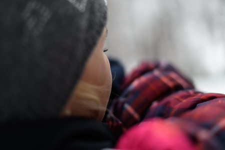 Little Girl Crying Mom is Holding Her Outside During a Snowfall