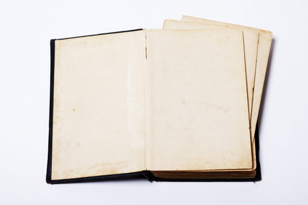 Open old map book on white background