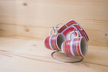 Two coffee mugs and saucers on a standの写真素材