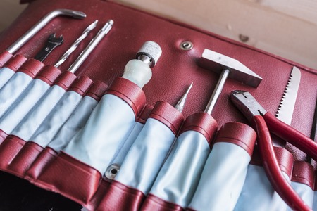 tools in red leather caseの写真素材