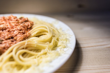 Spaghetti with meat sauce In wood contrasting backgroundの写真素材