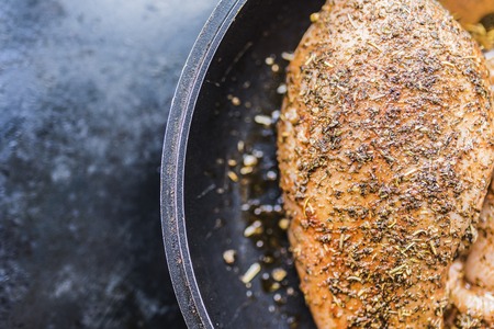 Fresh fillet of chicken breast marinated for barbecue on the right side of the frameの写真素材