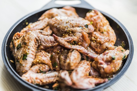 Fresh chicken wings in spicesの写真素材