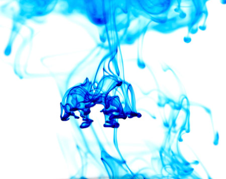 Abstract image of food coloring dispersing in water.の写真素材