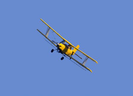 Image of aerial crop duster spraying corn field in rural Iowa.の写真素材