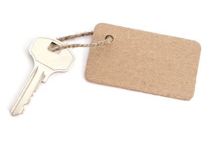 Carton tag with key isolated on white backgroundの写真素材