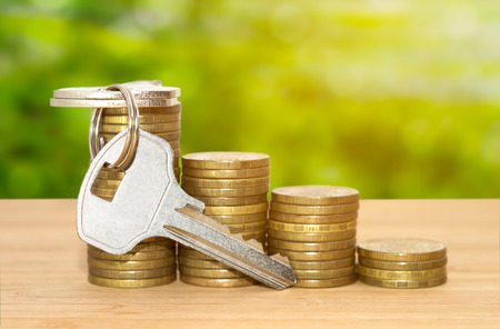 Coins stack loan with keys business conceptの写真素材