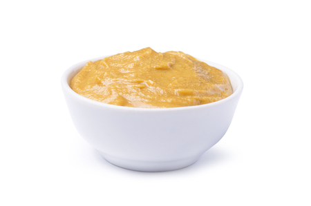 Tasty sauce mustard in a bowl isolated on white backgroundの写真素材
