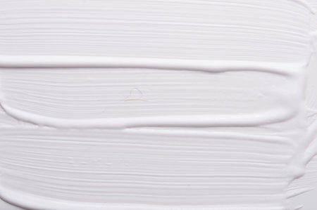 White cream painted with oil paint background textureの写真素材