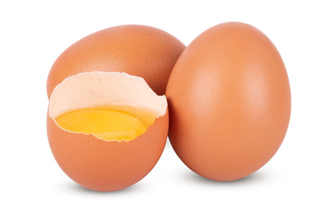 broken and whole brown eggs isolated on white background