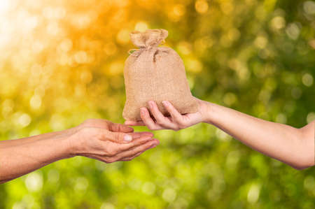Three burlap sack bags with rice isolated on white background.の写真素材