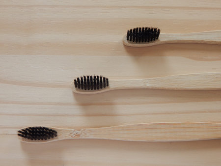Eco-friendly bamboo toothbrushes on a wooden background