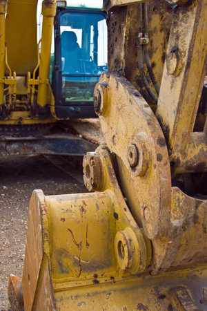 Close up of yellow Heavy Machinery Excavator at a construction siteの写真素材