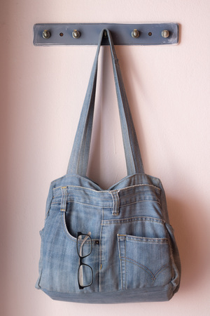 Upon the jeans bag on a clothesline.の写真素材