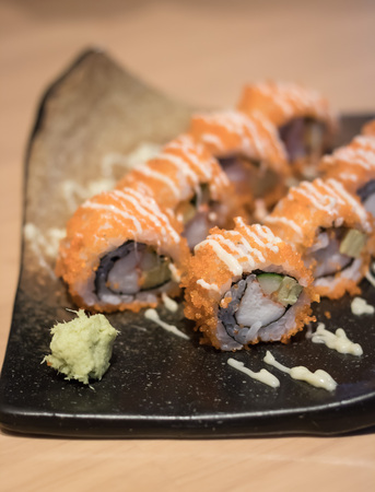 close up of sushi rolls on black plateの写真素材