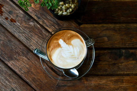 Cup of Latte coffee on wooden tableの写真素材