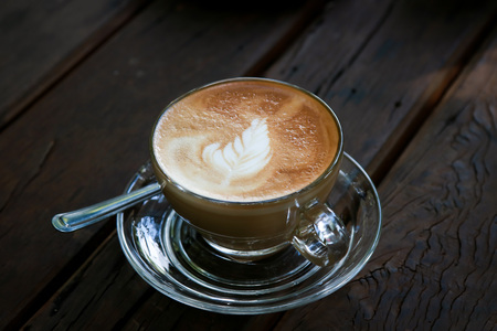 Cup of Latte coffee on wooden tableの写真素材