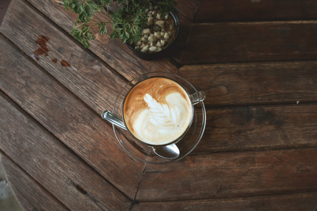 Cup of Latte coffee on wooden tableの写真素材