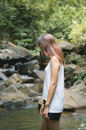 Alone girl in  the big forest wih sad emotionの写真素材