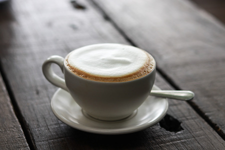 Cup of enery, Cappuccino coffee in white cup on wooden tableの写真素材