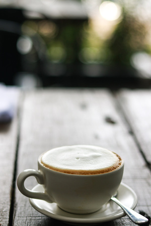 Cup of enery, Cappuccino coffee in white cup on wooden tableの写真素材