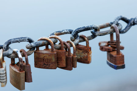 Padlocks on a chain on a background of blue sky, close-up