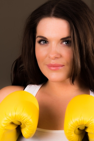 Young sporty female with boxing glovesの写真素材