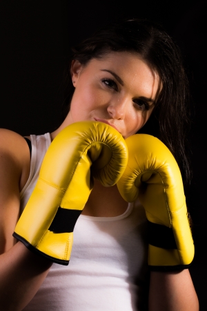 Young sporty female with boxing glovesの写真素材