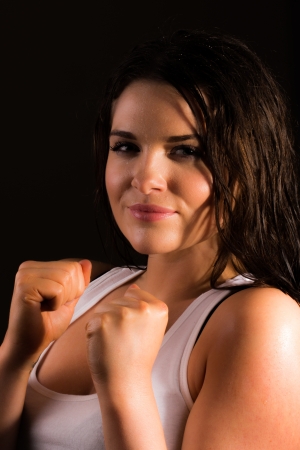 Young female trainer posing as boxerの写真素材