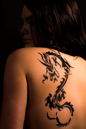 Beautiful female with tribal dragon tattoos の写真素材