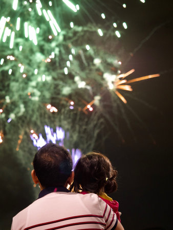 Dad and daughter enjoy fireworks in Koreaの写真素材
