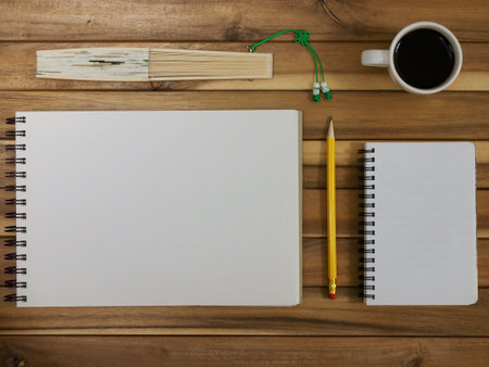 Sketchbook and pencil, coffee, fan, notepad