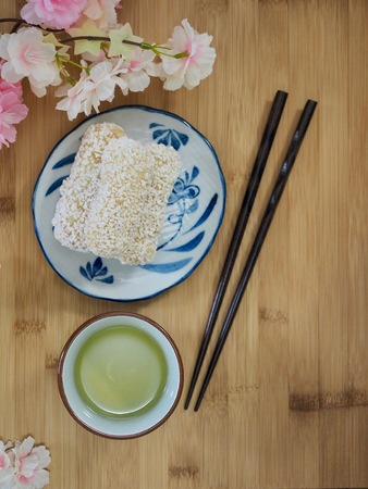Korean traditional sweets yugwa and green tea and cherry blossomsの写真素材